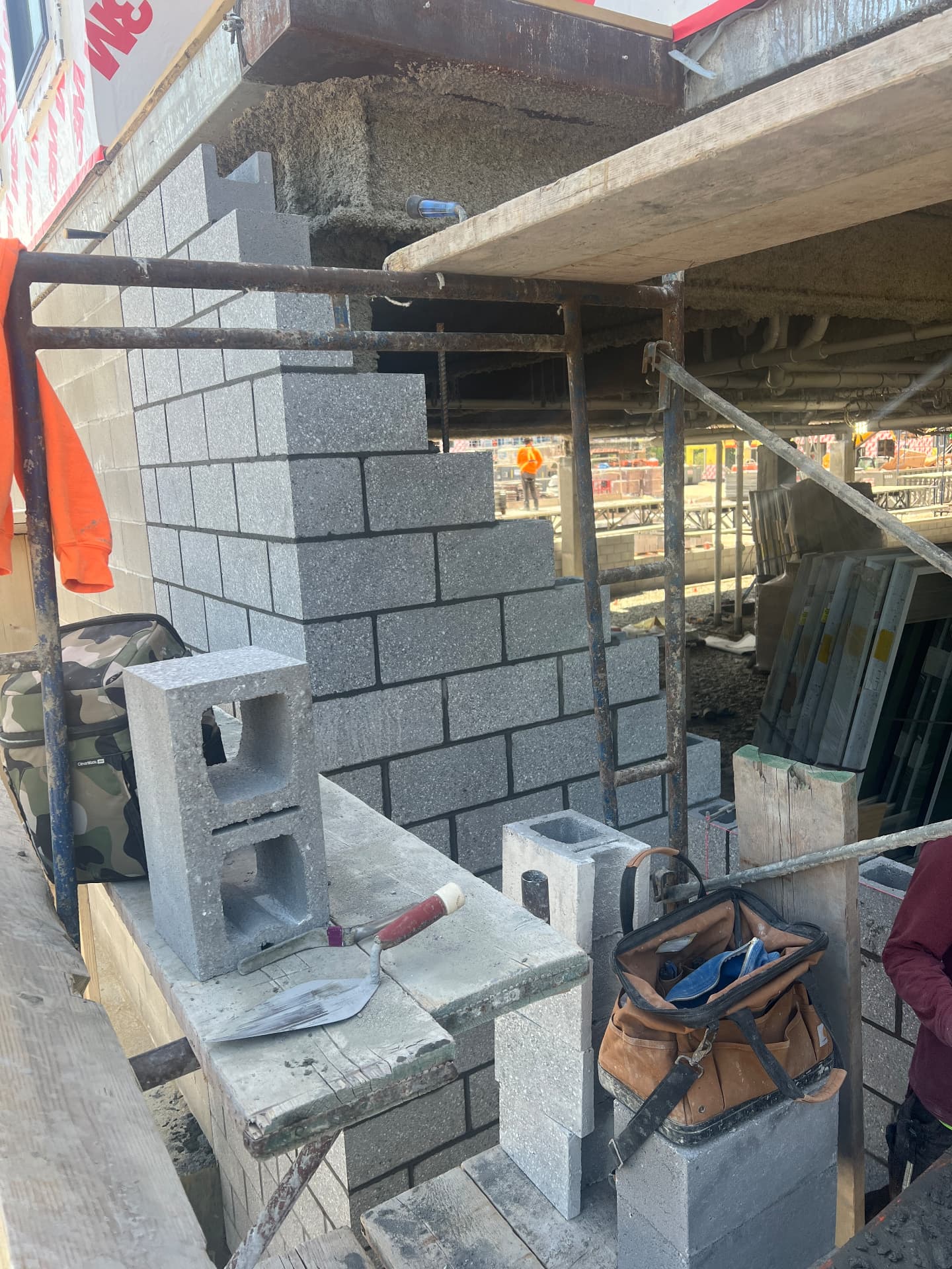 Concrete block wall built off staging on a commercial site