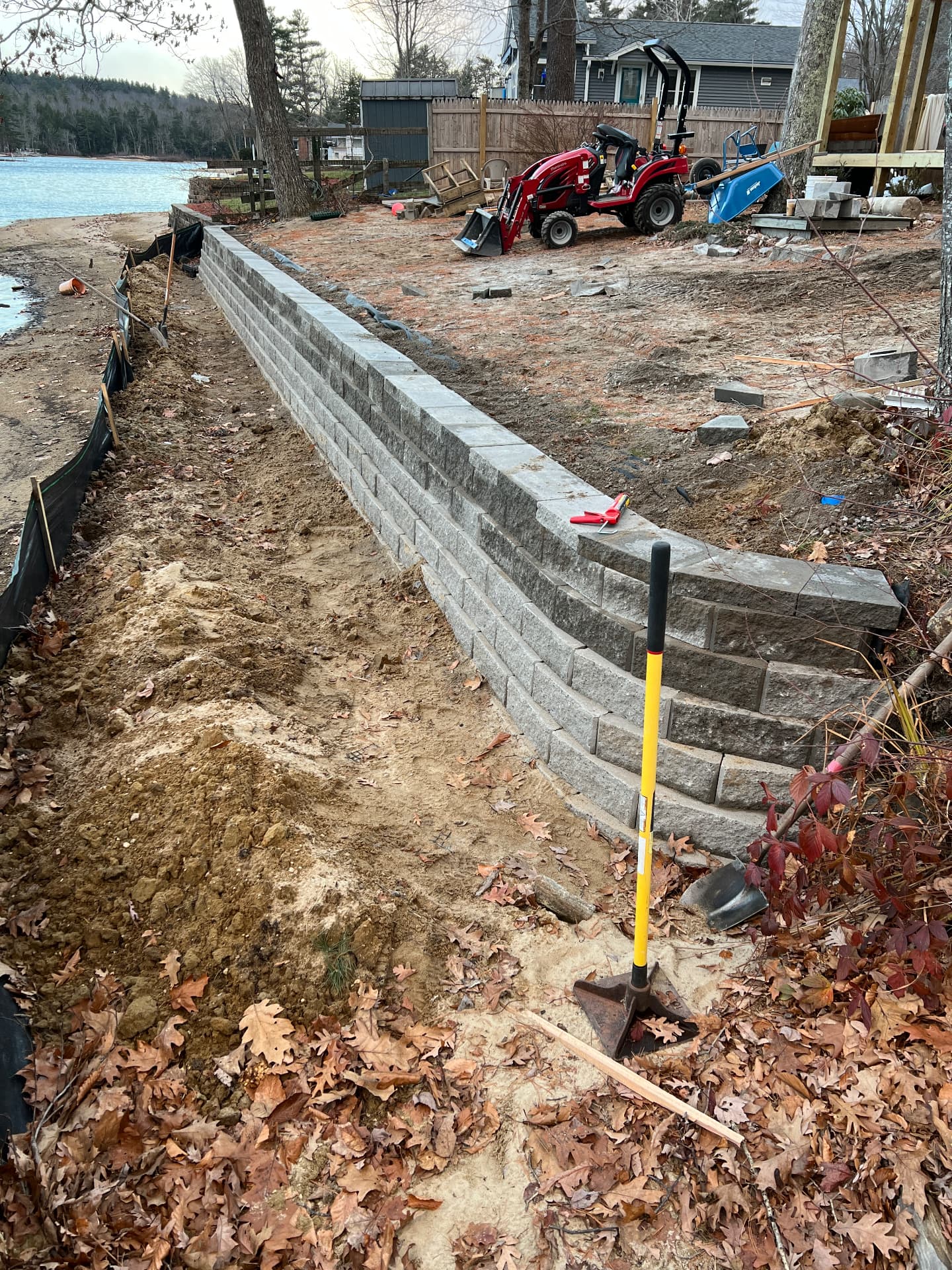Long curved block retaining wall beside a Maine lake
