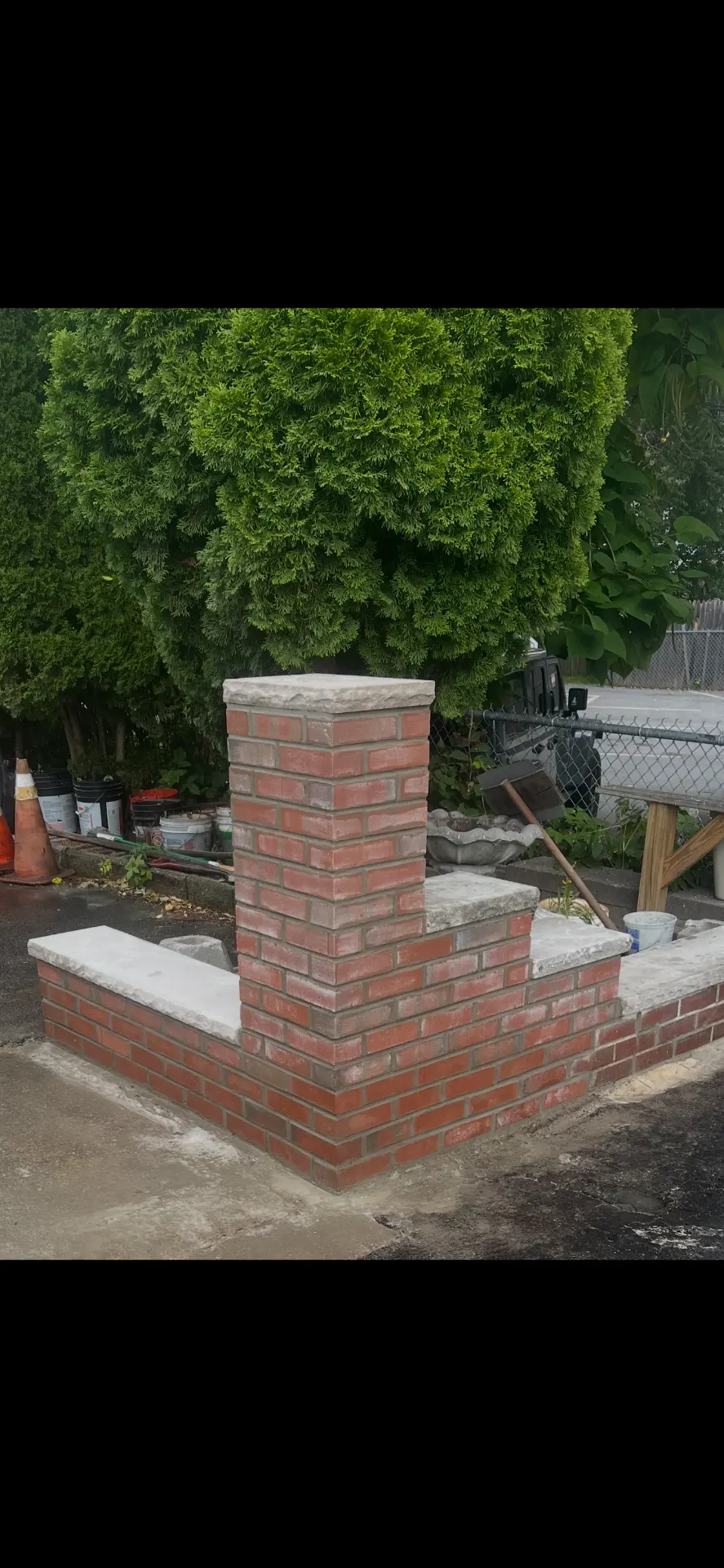 Red brick entry wall and pillar with cast stone caps