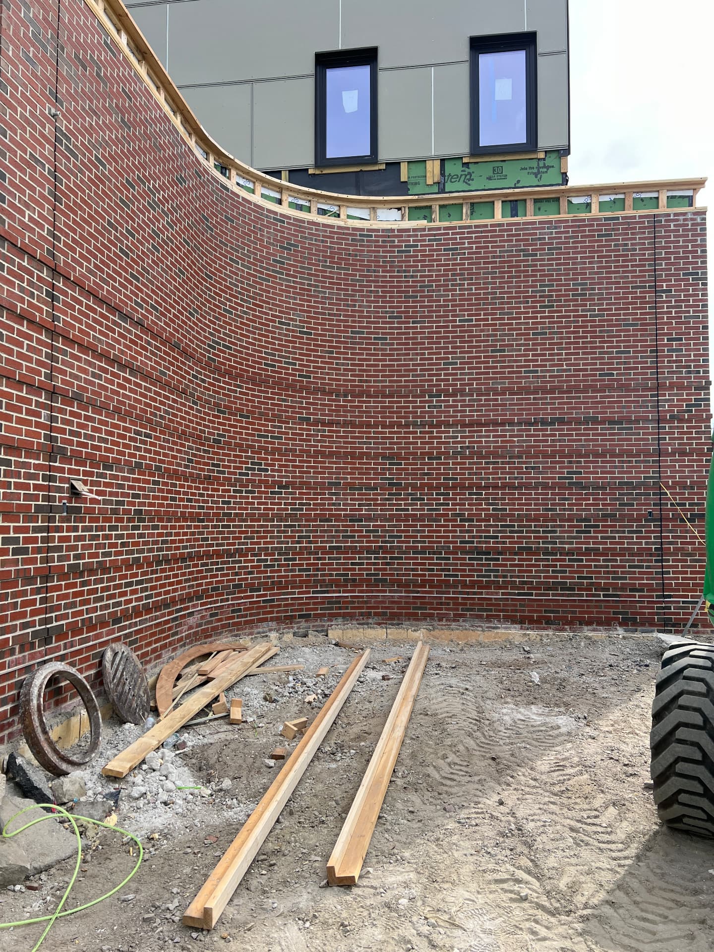 Large curved commercial brick masonry wall