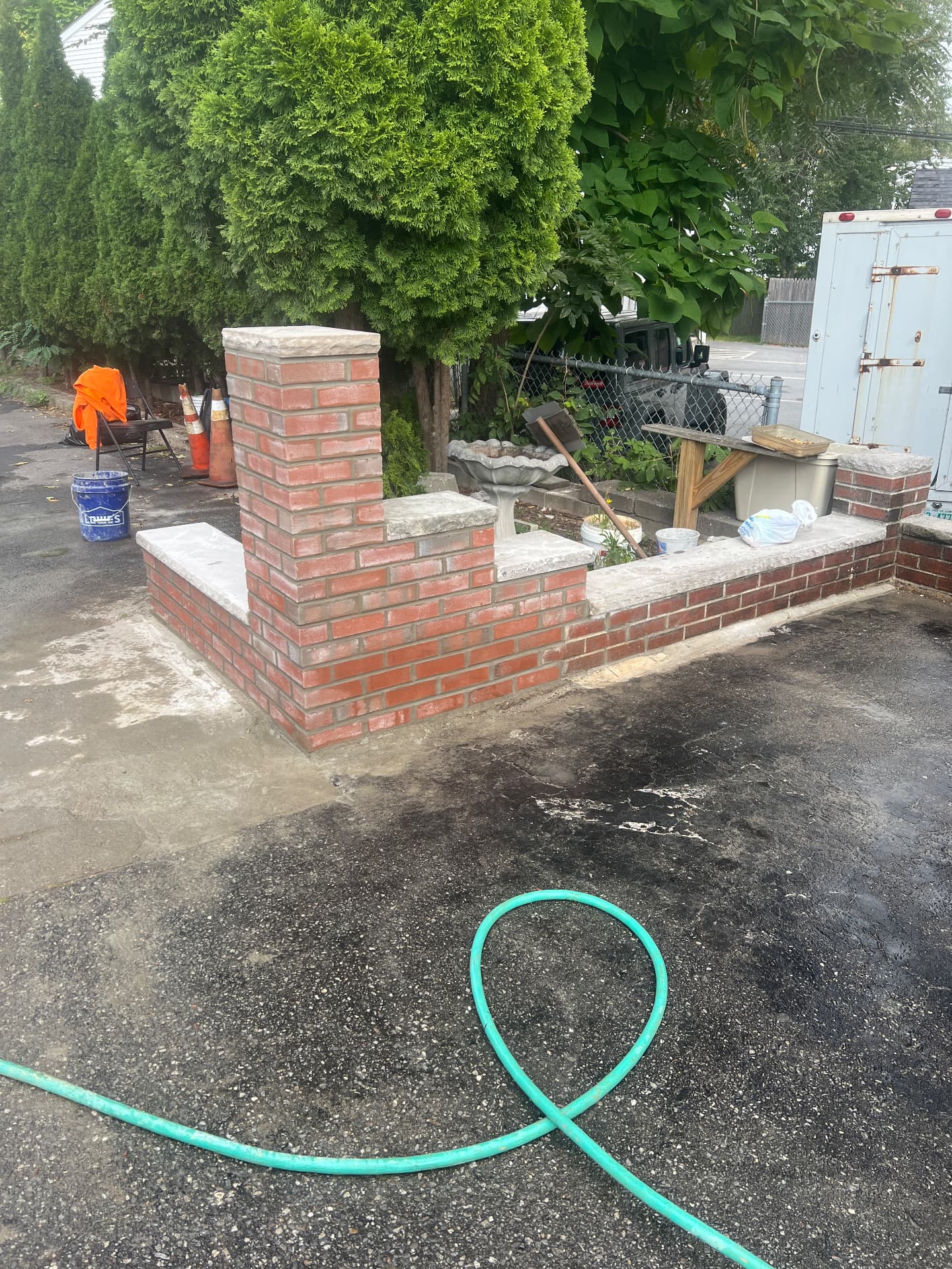 Custom red brick entry walls and pillars with stone caps